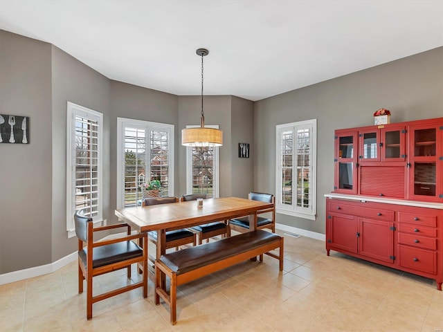 dining area featuring visible vents, baseboards, and light tile patterned flooring