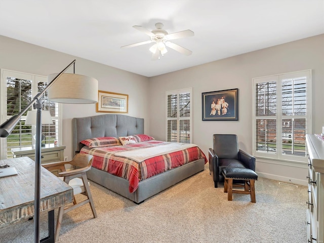 bedroom featuring ceiling fan, baseboards, and carpet floors