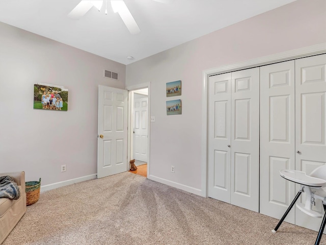 interior space with visible vents, baseboards, a closet, and a ceiling fan