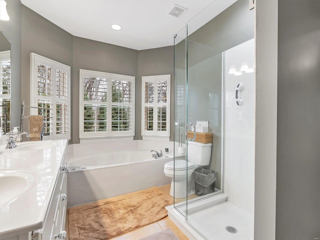 bathroom with tile patterned flooring, visible vents, a stall shower, and a sink