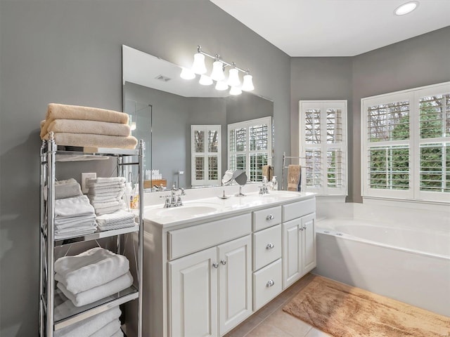 full bathroom with a sink, visible vents, a garden tub, and tile patterned floors