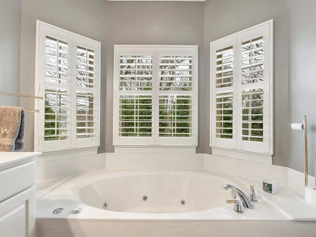 full bathroom featuring vanity and a whirlpool tub