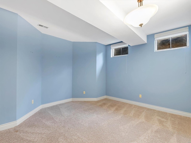 interior space with carpet flooring, baseboards, and visible vents