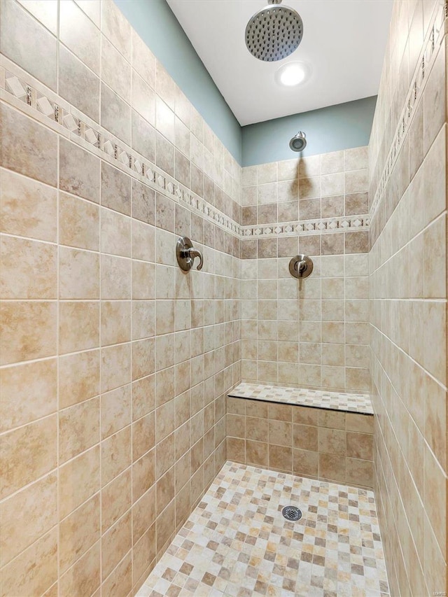 full bath featuring tiled shower