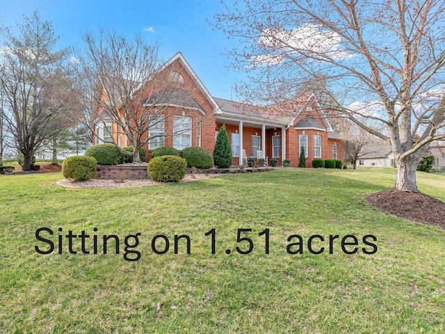 view of front of property with brick siding and a front lawn