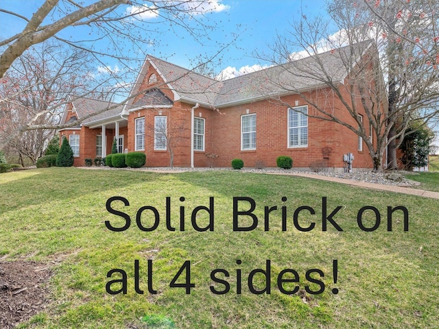 view of front of house with brick siding and a front yard