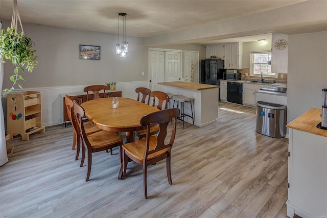 dining area featuring light wood-style floors