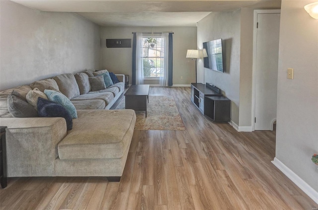 living room featuring baseboards and wood finished floors