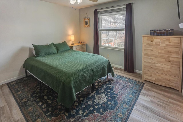 bedroom with baseboards and wood finished floors