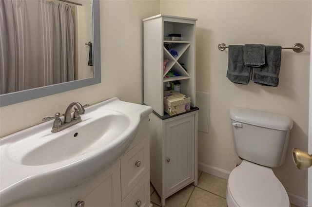 bathroom featuring tile patterned floors, toilet, vanity, and baseboards