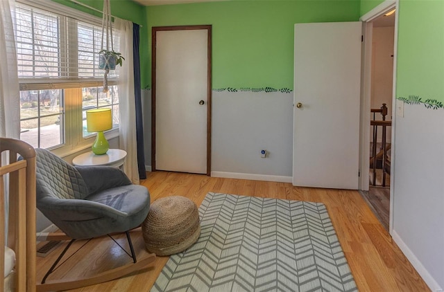 sitting room with wood finished floors and baseboards