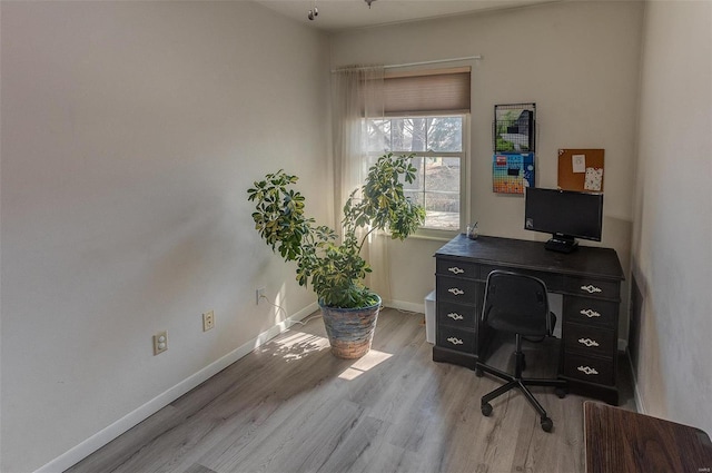 office space featuring light wood-type flooring and baseboards