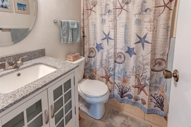 bathroom featuring tile patterned floors, toilet, a shower with shower curtain, and vanity