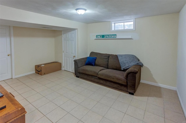 living area featuring light tile patterned flooring, visible vents, and baseboards