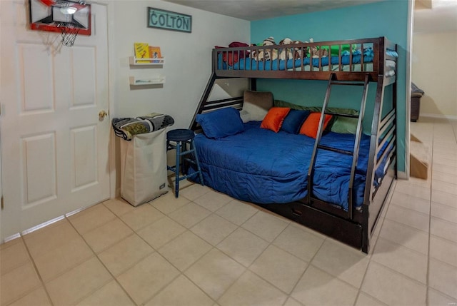 tiled bedroom featuring baseboards