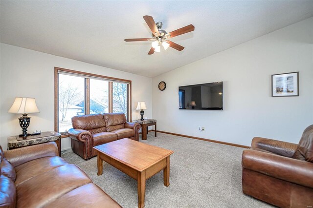 living area with lofted ceiling, light colored carpet, baseboards, and ceiling fan