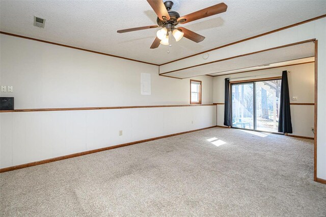 carpeted empty room featuring a textured ceiling and crown molding