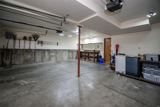 garage with a workshop area and a garage door opener