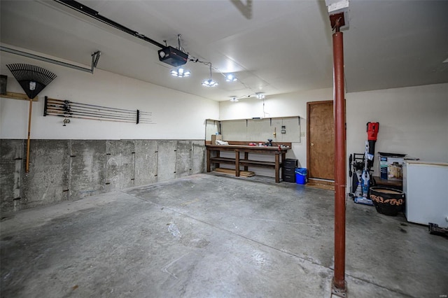 garage with a workshop area and a garage door opener