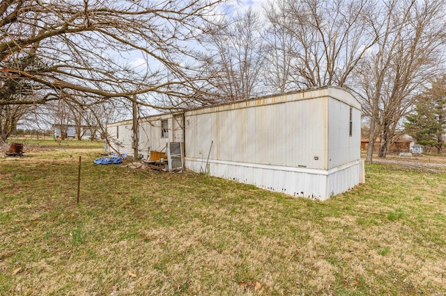 view of side of home featuring a yard