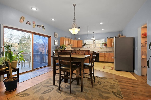 dining space with recessed lighting and light wood finished floors