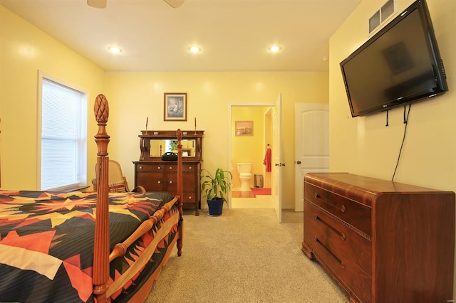 bedroom featuring light carpet, visible vents, recessed lighting, and ensuite bath