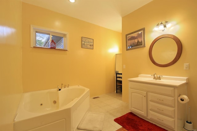 bathroom with tile patterned floors, visible vents, a jetted tub, and vanity