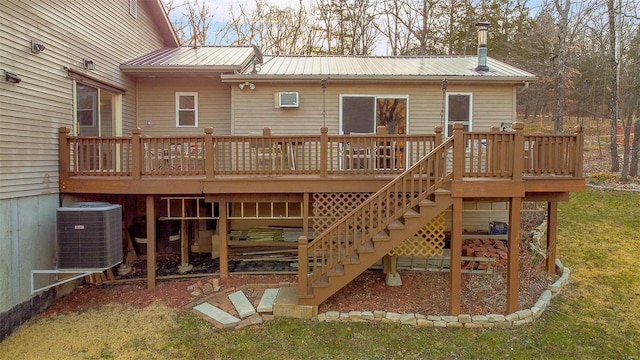 back of property with central AC unit, metal roof, stairs, and a deck