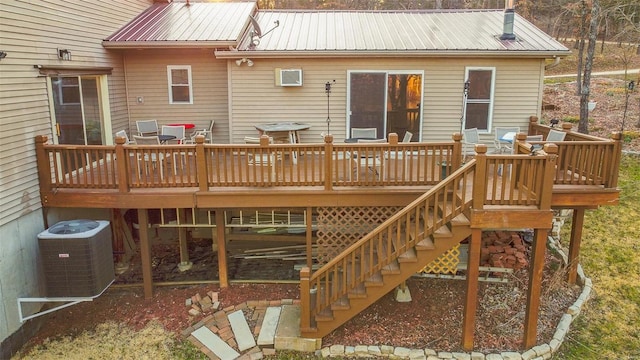 back of property with a deck, stairway, central AC, and metal roof