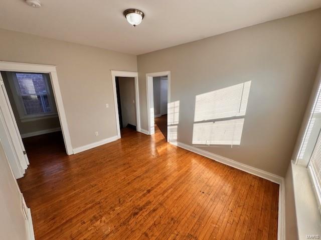 unfurnished bedroom featuring baseboards and wood finished floors