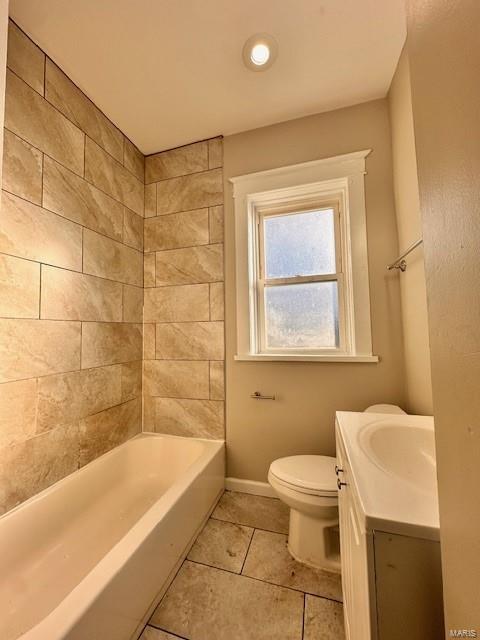 full bathroom with baseboards, toilet, vanity, and tile patterned flooring