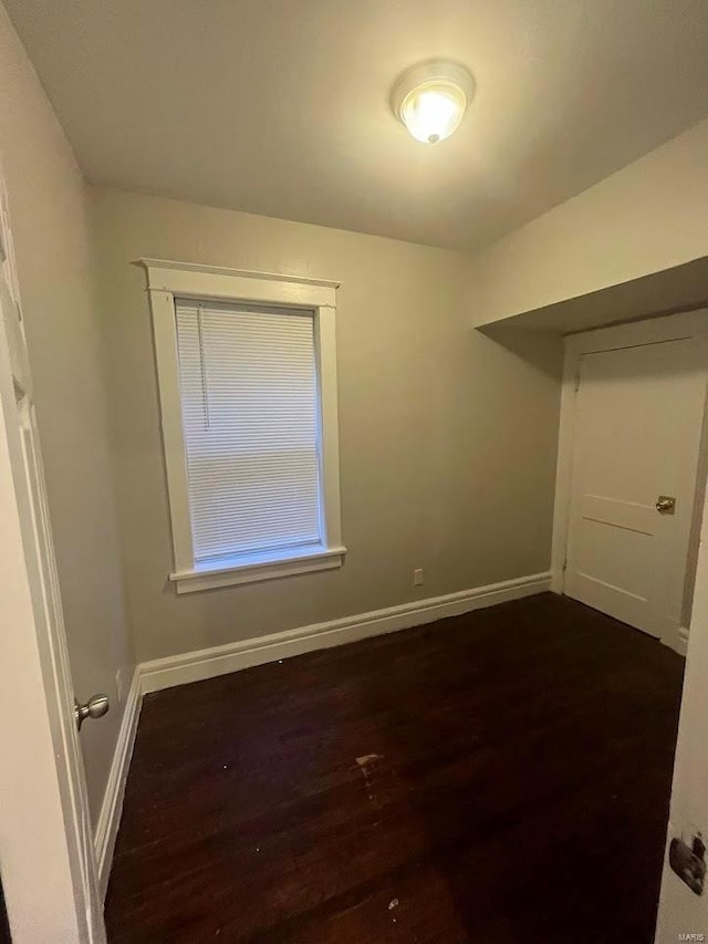 interior space with baseboards and dark wood finished floors