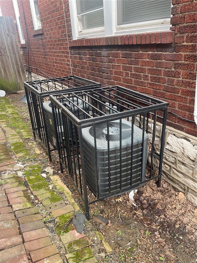 exterior details with brick siding and central AC unit