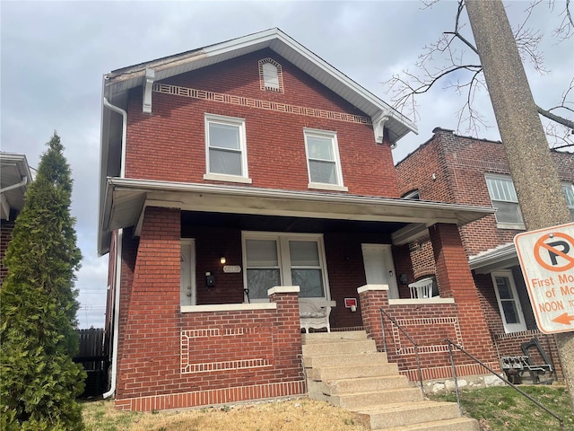 view of front of house featuring covered porch and brick siding