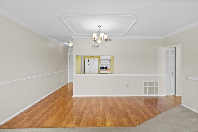 unfurnished room featuring visible vents, a notable chandelier, and ornamental molding