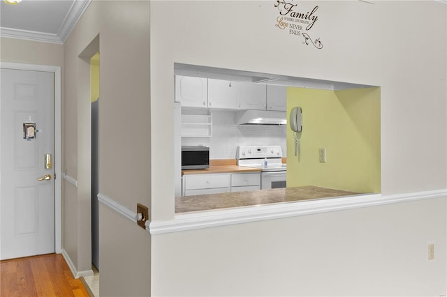 kitchen with ornamental molding, under cabinet range hood, stainless steel microwave, wood finished floors, and white range with electric stovetop