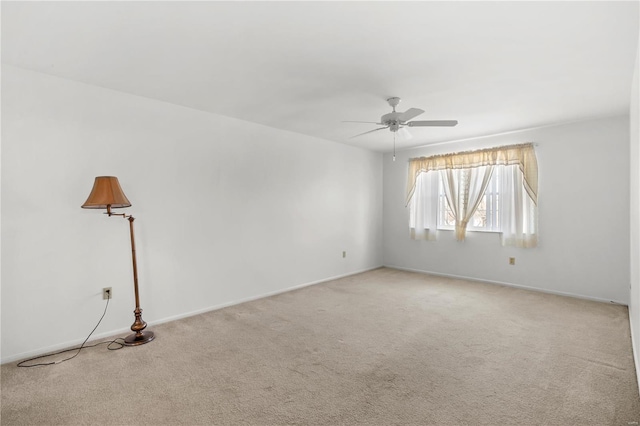 spare room with carpet floors and a ceiling fan