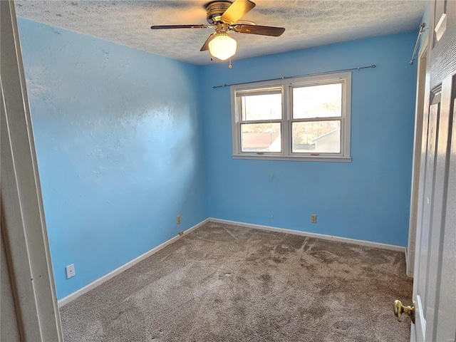 unfurnished bedroom with carpet flooring, ceiling fan, a textured ceiling, and baseboards