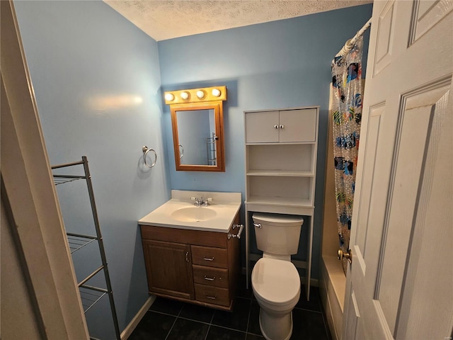 bathroom with toilet, a textured ceiling, tile patterned flooring, baseboards, and vanity