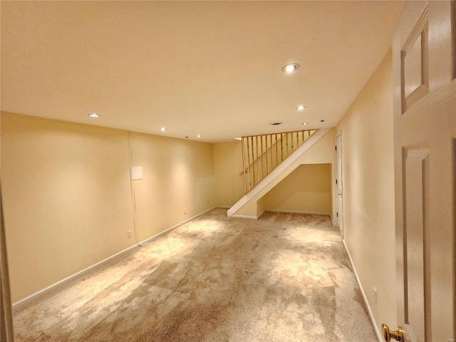 finished basement featuring stairs, recessed lighting, light colored carpet, and baseboards