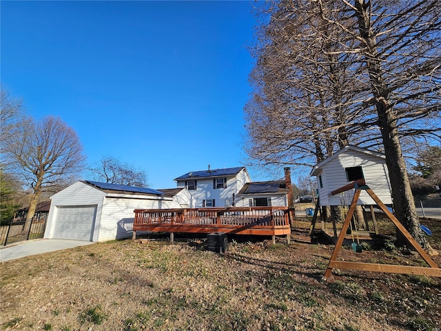 exterior space featuring a deck, driveway, and fence