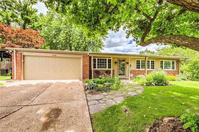 ranch-style home with a garage, brick siding, concrete driveway, and a front lawn