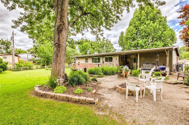 rear view of house with a lawn and fence