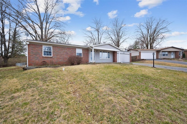 ranch-style home featuring a front yard and brick siding