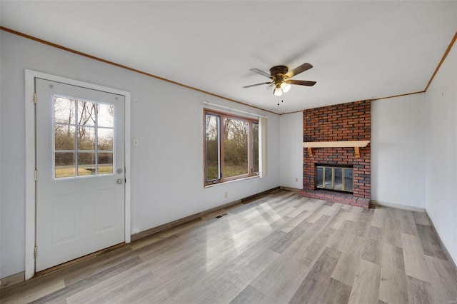 unfurnished living room featuring light wood finished floors, a ceiling fan, and ornamental molding