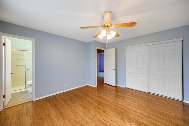 unfurnished bedroom featuring ensuite bath, baseboards, light wood-type flooring, and a closet