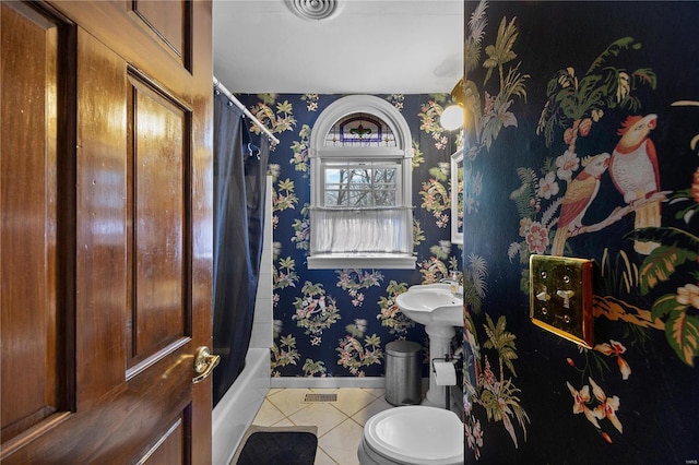 full bath featuring tile patterned floors, toilet, shower / tub combo, wallpapered walls, and baseboards