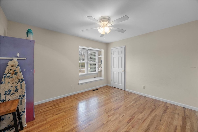 unfurnished bedroom with visible vents, baseboards, and wood finished floors