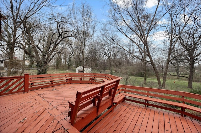 deck featuring an outdoor structure and a storage unit