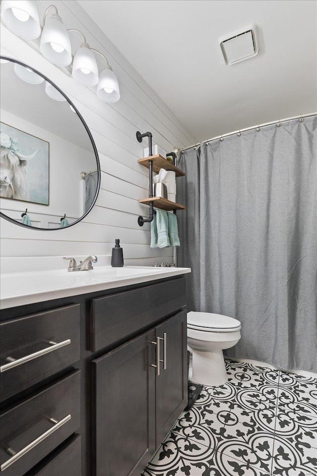 bathroom featuring tile patterned floors, curtained shower, toilet, and vanity